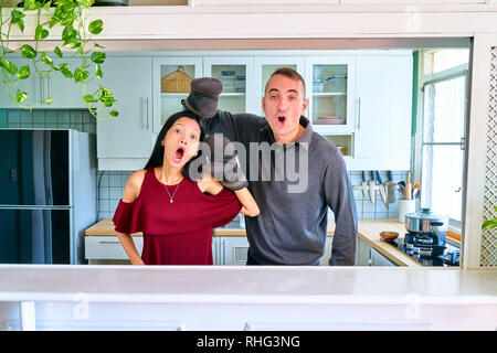 Lovely couple posing - playing the puppet hands and making a face Stock Photo