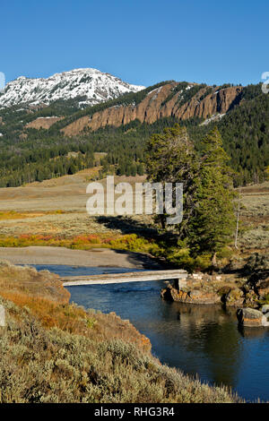WY03092-00...WYOMING - Trail bridge over Soda Butte Creek in the Lamar Valley area of Yellowstone National Park. Stock Photo