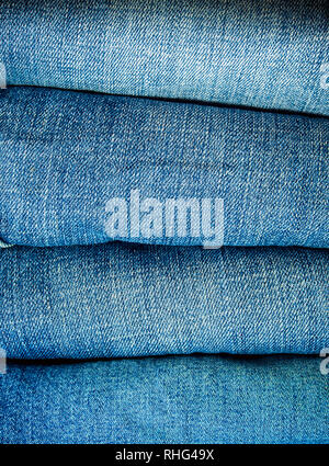 Pile of different blue jeans, fabric texture Stock Photo