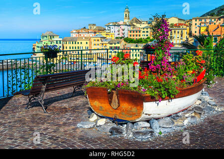 Fantastic mediterranean beach destination. Paved promenade and wooden boat decorated with colorful flowers, Bogliasco, Liguria, Italy, Europe Stock Photo