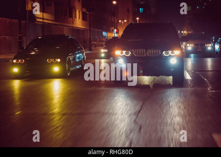 Cars in the night traffic jam . Looking behind the cars.Cars are red, yellow night light. Traffic jams in the city with row of cars on the road at nig Stock Photo