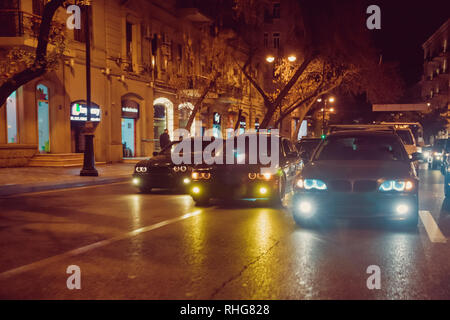 Night view of the cars. Road in the city at the night with yellow and red electrical light for cars during they are coming home. The cars compete at Stock Photo