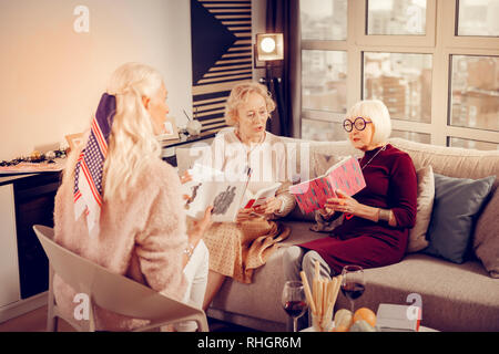 Nice smart aged women discussing different books Stock Photo