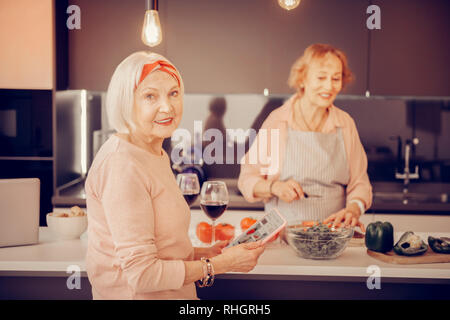 Cheerful nice woman using a modern tablet Stock Photo