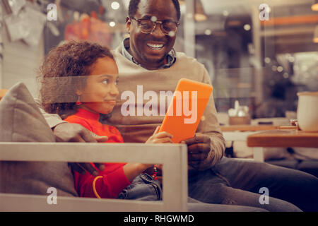 Cheerful loving father feeling amazing spending day with daughter Stock Photo