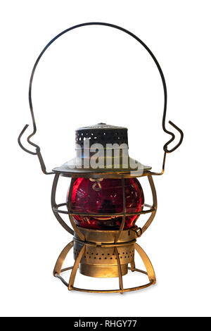 Vintage kerosene oil railroad lantern with red glass globe, isolated on white background. Stock Photo