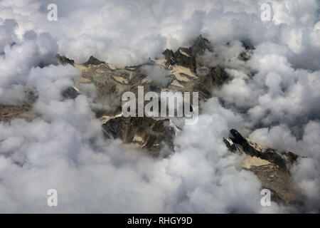 Mountain peaks among the clouds, dramatic weather, a thunderstorm in mountains. Stock Photo