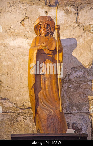 Statue of St James the Apostle in the abbey church of St Foy in Conques France.  The abbey has been an important stop for pilgrims on the Santiago de  Stock Photo
