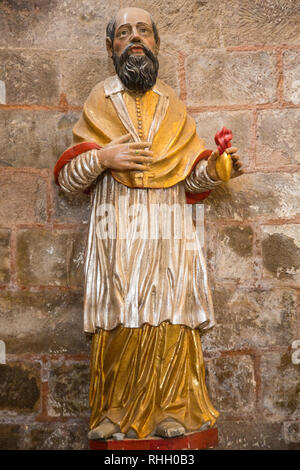 Statue of St Francois de Sales in the abbey church of St Foy in Conques France.  The abbey has been an important stop for pilgrims on the Santiago de  Stock Photo