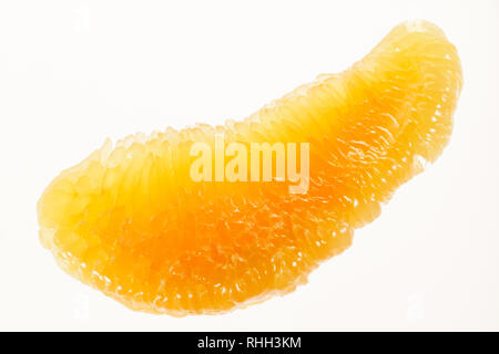Peeled pomelo slice on a white background. Pomelo fruit macro photography. Stock Photo