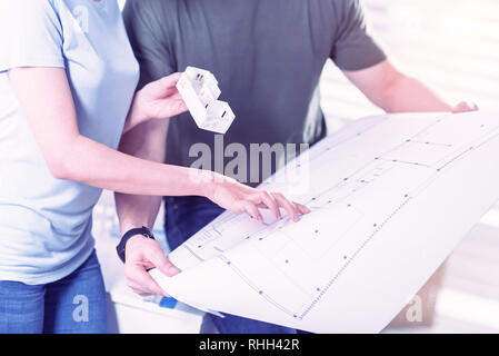 Two architects standing together and touching their new blueprint Stock Photo