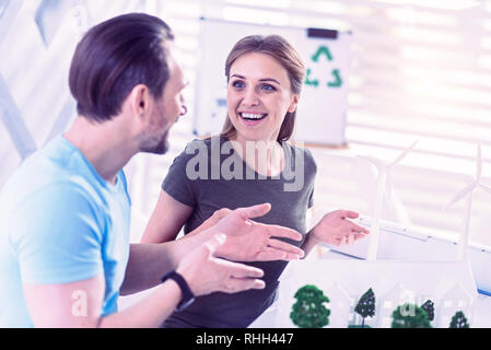 Young engineer feeling excited while talking about her eco project Stock Photo