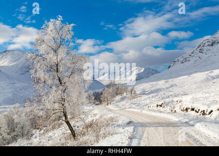 hoar frost turns the scene into a winter wonderland along the long road by Coupall Falls to Glen Etive at Rannoch Moor, Highlands, Scotland in Winter Stock Photo