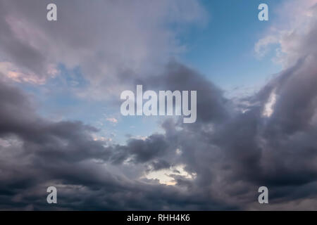 Unusual cloudy skies with dramatic grey clouds with some blue sky. Stock Photo