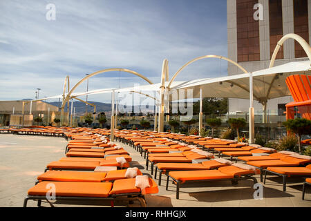 Lounge chairs near the pool at the Grand Sierra Resort and Casino, Reno, Nevada, United States Stock Photo