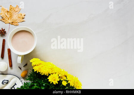 Autumn background flat-lay. Hot chocolate, plaid, fresh flowers, dried leaves. Autumn, fall concept. Stock Photo