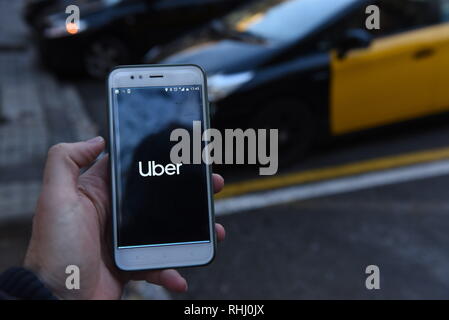 Barcelona, Spain. 2nd Feb, 2019. A man holds up a smartphone showing the Uber app in Barcelona, where ride-hailing companies Uber and Cabify suspended their services on last January 31, 2019 due to the new restrictions approved by the Catalan government on how they operate in this spanish city. Credit: John Milner/SOPA Images/ZUMA Wire/Alamy Live News Stock Photo