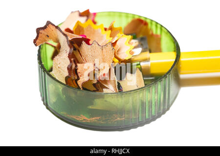 Pencil sharpener with color shavings on a white background. Side view Stock Photo