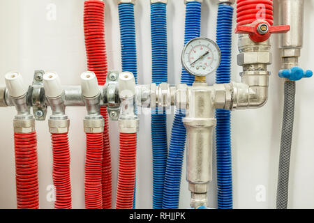 Plastic pipes of central heating system and water pipes in apartment during under renovation, remodeling and construction Stock Photo