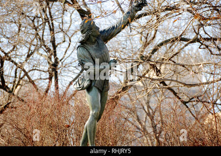 A cast iron sculpture called 'The Falconer' is one of the public art pieces in New York City's Central Park. Stock Photo