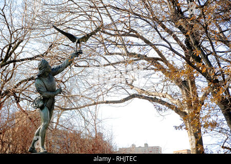 A cast iron sculpture called 'The Falconer' is one of the public art pieces in New York City's Central Park. Stock Photo