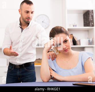 Sad female is depressing and husband is supporting her at home. Stock Photo