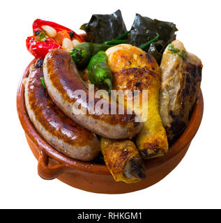 Kapama  a dish of bulgarian cuisine with assortiment meat, grape rolls and  stuffed pepper. Isolated over white background Stock Photo