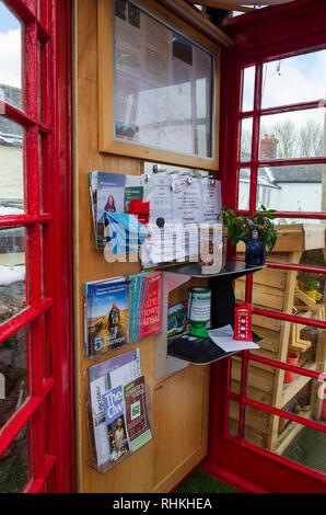 February 2, 2019 Tremeirchion, UK. A traditional British telephone box has been repurposed as a tourist and community information booth. Stock Photo