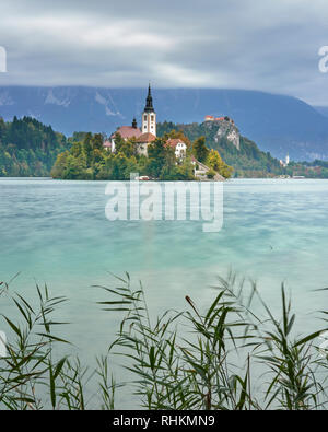 Church Of The Assumption on Blejski Otok with Bled Castle, Lake Bled, Bled, Gorenjska, Slovenia Stock Photo