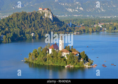 Church Of The Assumption on Blejski Otok with Bled Castle, Lake Bled, Bled, Gorenjska, Slovenia. Stock Photo