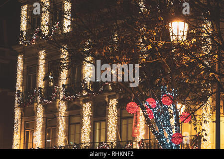illuminated red balls, tree lights and christmas building decorations in Lisbon, Portugal Stock Photo