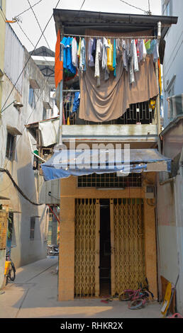 A house in a small residential back street in the Tran Hung Alleys area of District 1 in Saigon. Stock Photo