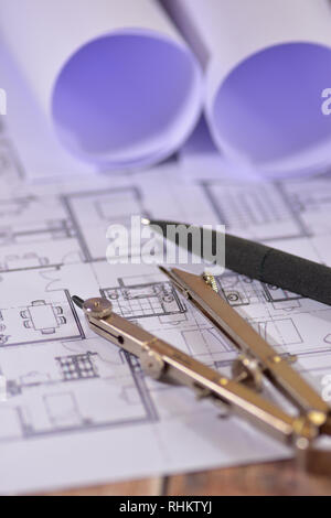 Architects drawings on a wooden table Stock Photo