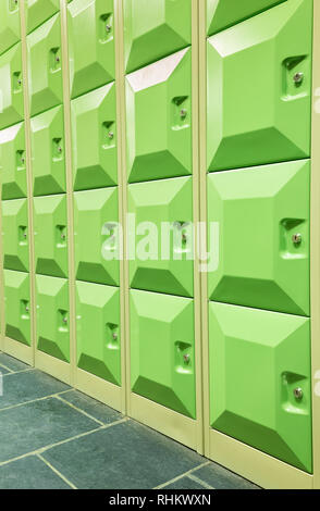 Rows of green student lockers in  hall of high school Stock Photo