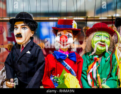 Row of traditional puppets - gentleman, clown and musician Stock Photo