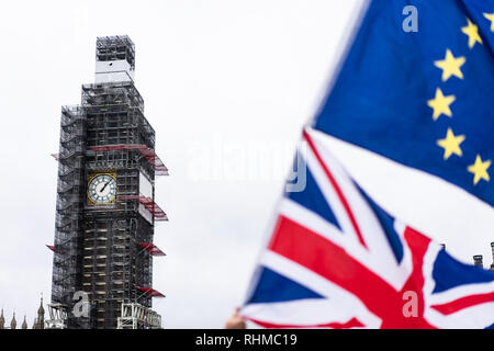 Big Ben at Parliament covered in scaffolding with the Union Fag and European Union Flag in the foreground. London UK Stock Photo