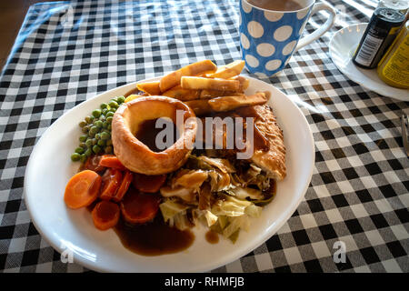 Plated Hot Steak meat Pie with Chips and gravy British Meal on a plastic gingham table cloth in a Doncaster Cafe, Yorkshire, England Stock Photo