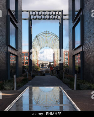 Historic airship hangar, built in 1912 on original Farnborough Airfield site, now Farnborough Business Park. Structure is reflected in pool of water. Stock Photo