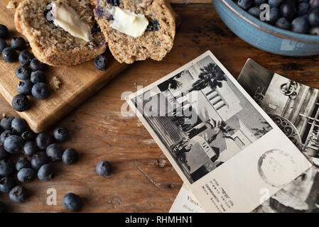 muffins and vintage postcards on wood table Stock Photo