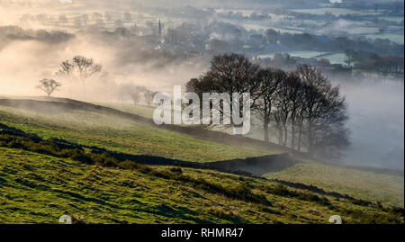 Bamford village shrouded in a mist inversion, from New Road below Bamford edge (2) Stock Photo