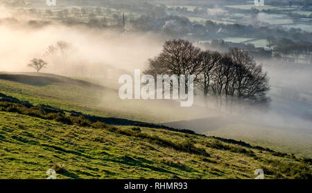 Bamford village shrouded in a mist inversion, from New Road below Bamford edge (3) Stock Photo