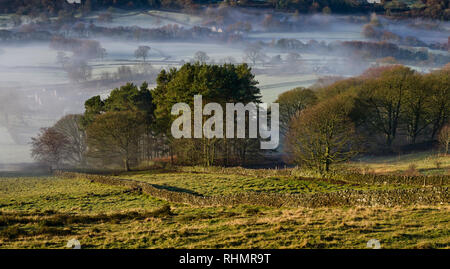 Bamford village shrouded in a mist inversion, from New Road below Bamford edge (4) Stock Photo