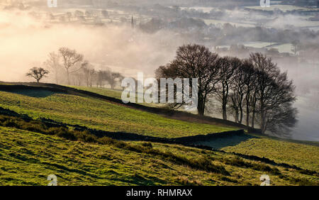 Bamford village shrouded in a mist inversion, from New Road below Bamford edge (5) Stock Photo