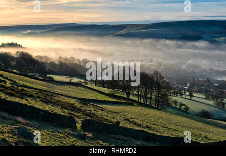 Bamford village shrouded in a mist inversion, from New Road below Bamford edge (7) Stock Photo