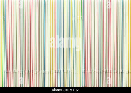 Striped colored plastic cocktail straws as background Stock Photo