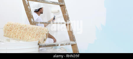 painter man at work, with wooden ladder and  blank wall for copy space, web banner template Stock Photo