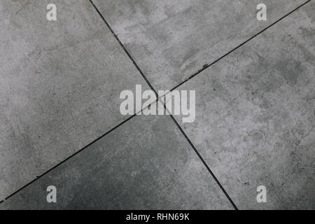 Dark grey black cement floor abstract background texture. Blank dark grey worn floor lines and tiles. Abstract background Stock Photo