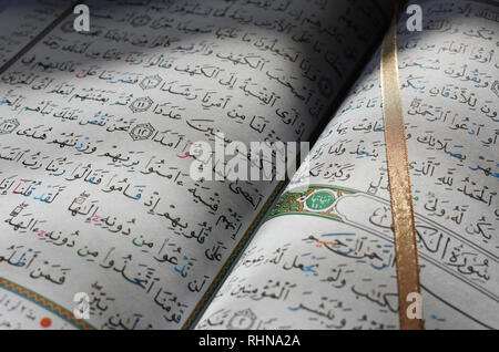 The Holy Quran open at Surah Al Kahf - Chapter 18 - in beautiful sunlight Stock Photo