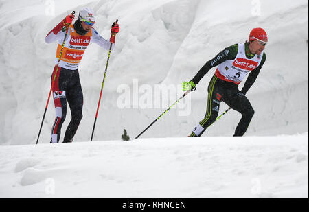 Klingenthal, Germany. 03rd Feb, 2019. Nordic Combined, World Cup, Single, Large Hill, 10 km. Fabian Rießle (r) from Germany runs on the track ahead of Jarl Magnus Riiber from Norway. Credit: Hendrik Schmidt/dpa-Zentralbild/dpa/Alamy Live News Stock Photo