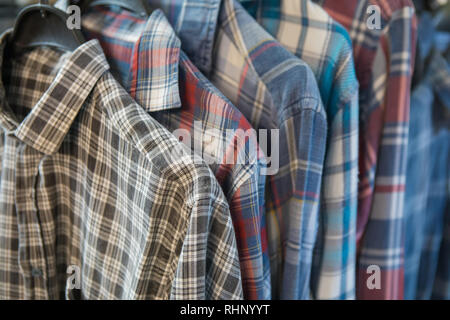 Group of Colored Cotton Shirts. Assorted shirt fabric samples. Textured shirt fabric background Stock Photo